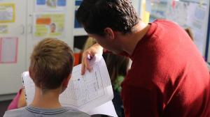 Teacher reading with student.